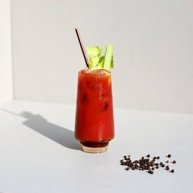 A Bloody mary cocktail with tomato juice, celery and peppercorns